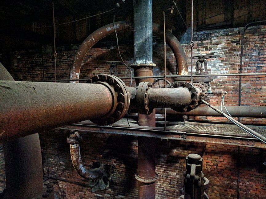 large rusting pipes of old boiler