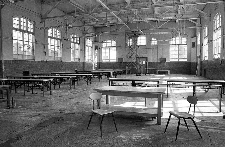 inside empty dining hall with many tables