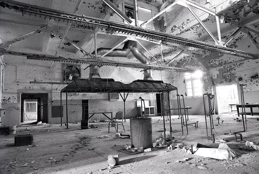 inside kitchen of Penitentiary with large hoods looming above