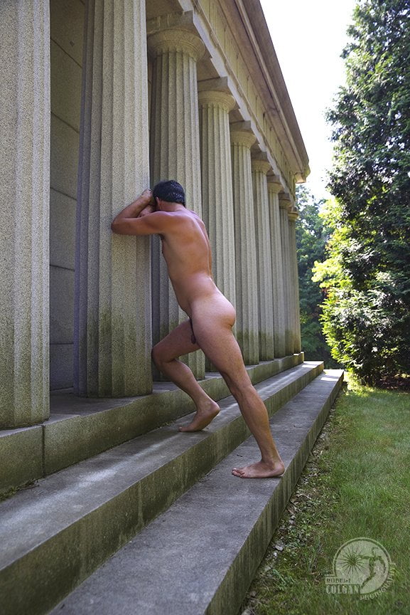 nude man leaning against classical columned structure