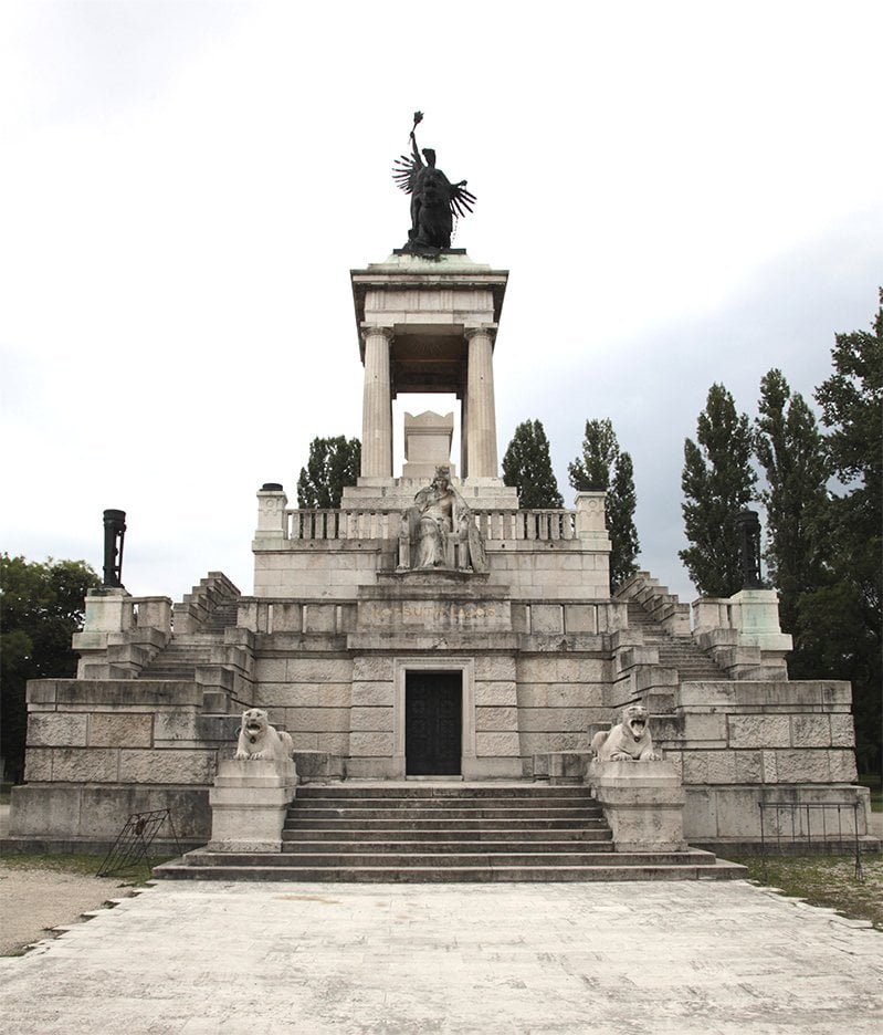 large marble monument with multiple figures and steps to the top, a tomb for Kossuth