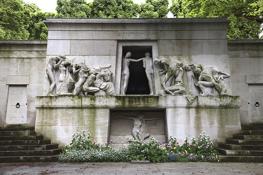 Egyptian style tomb with multiple figures approaching doorway