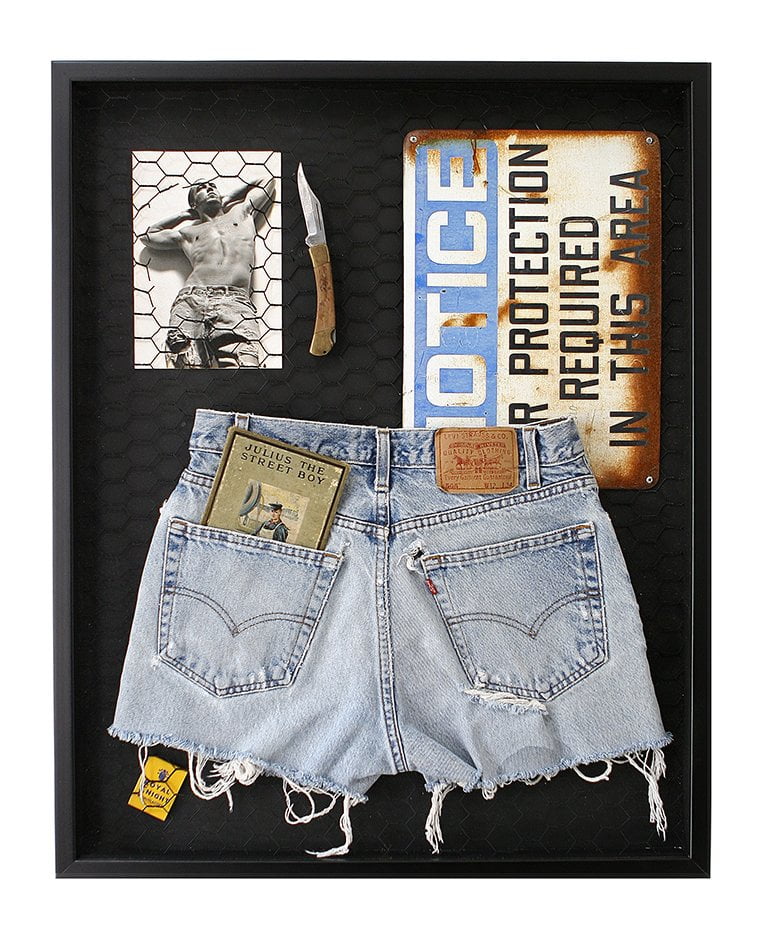 shadow box with image of man with descriptive ephemera