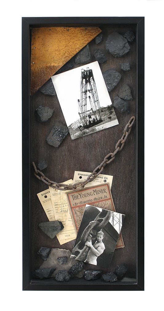 shadow box with image of man with descriptive ephemera