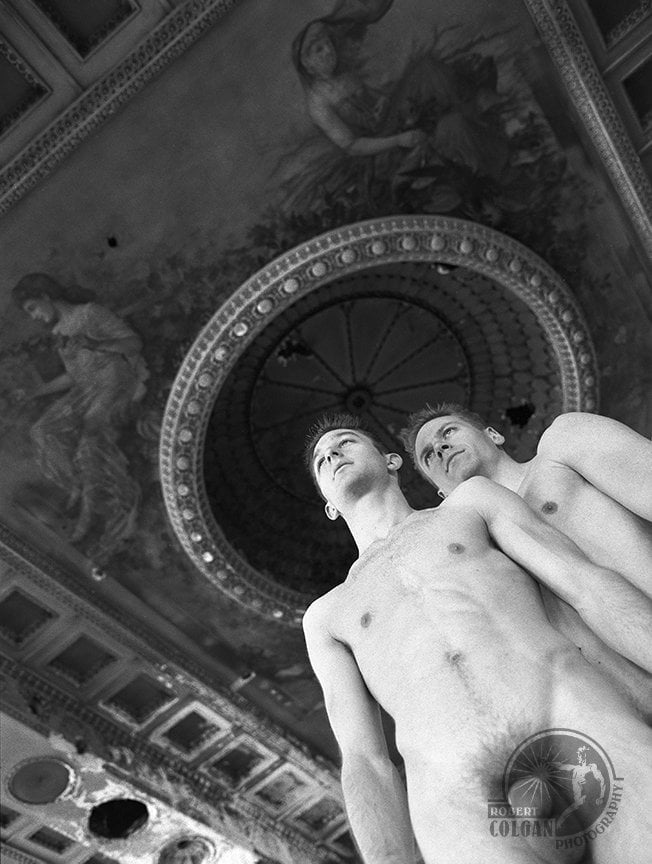 upward view of two nude men with intricate painted ceiling
