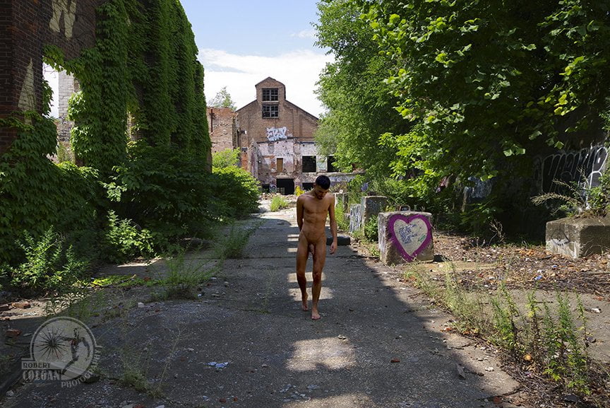 nude man walks in ruins of old factory