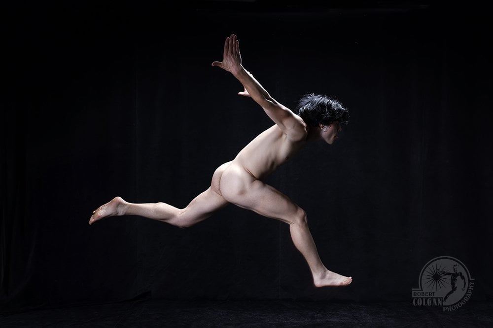nude man from side, running with arms thrown back