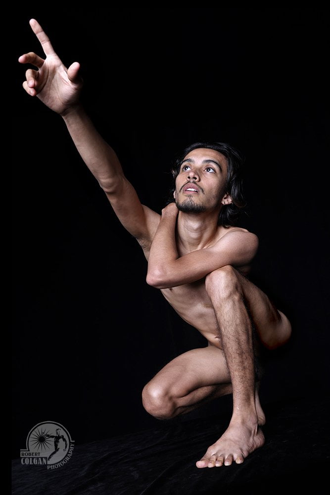 nude man pointing upward