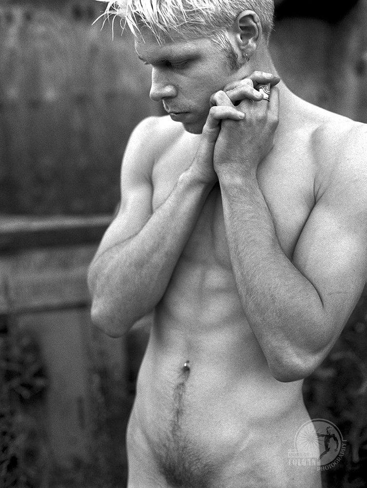 nude male standing with arms together