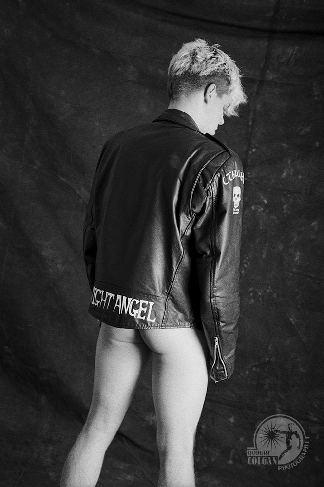 naked man with leather coat shot from behind
