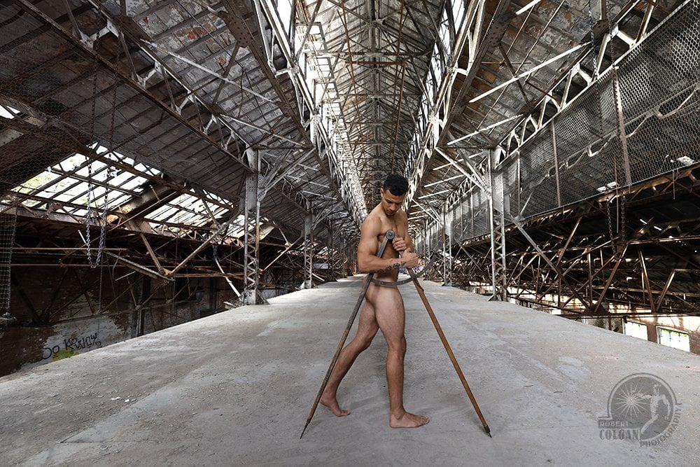 nude man with large calipers in old factory