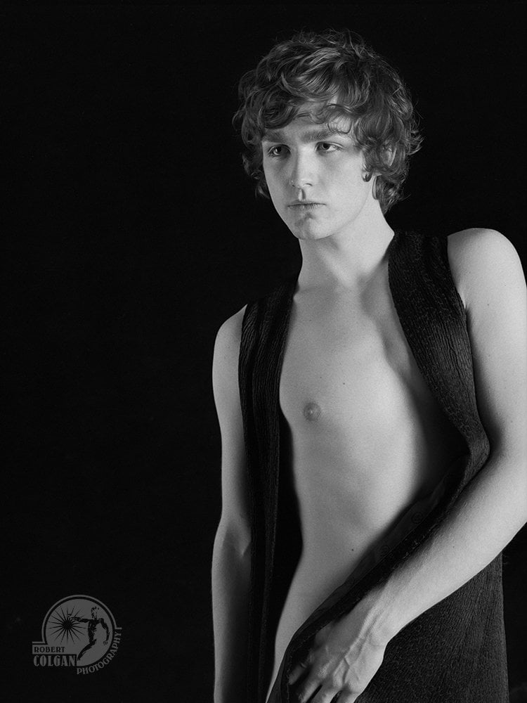 partially nude man standing in studio
