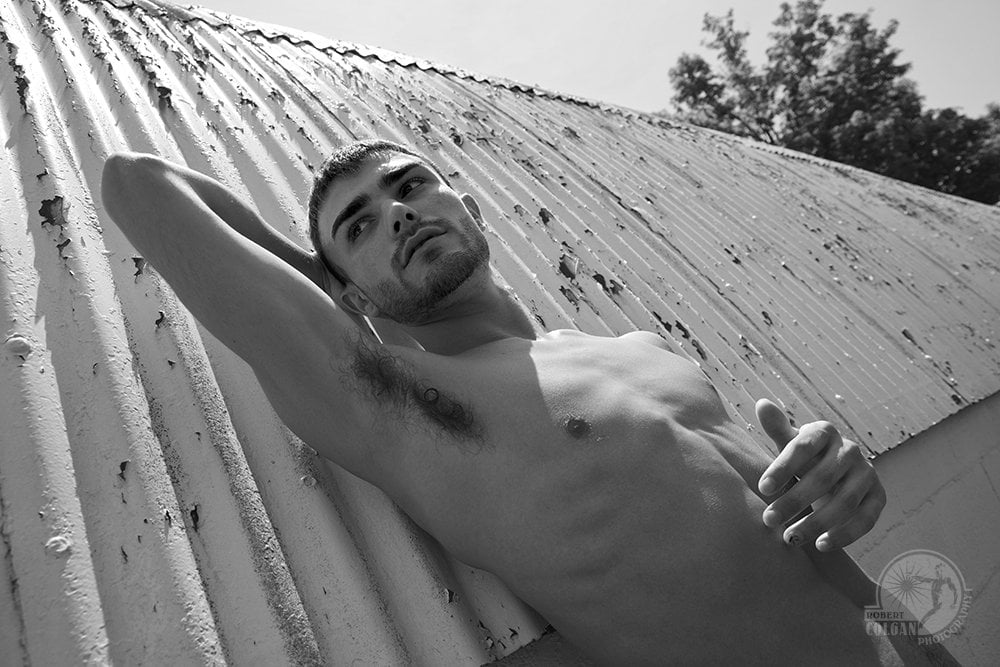 close-up of shirtless man on corrugated metal