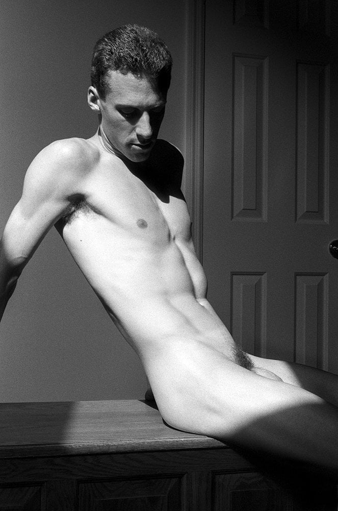nude man sitting on bench