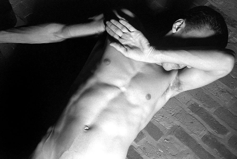 nude man with arm over eyes