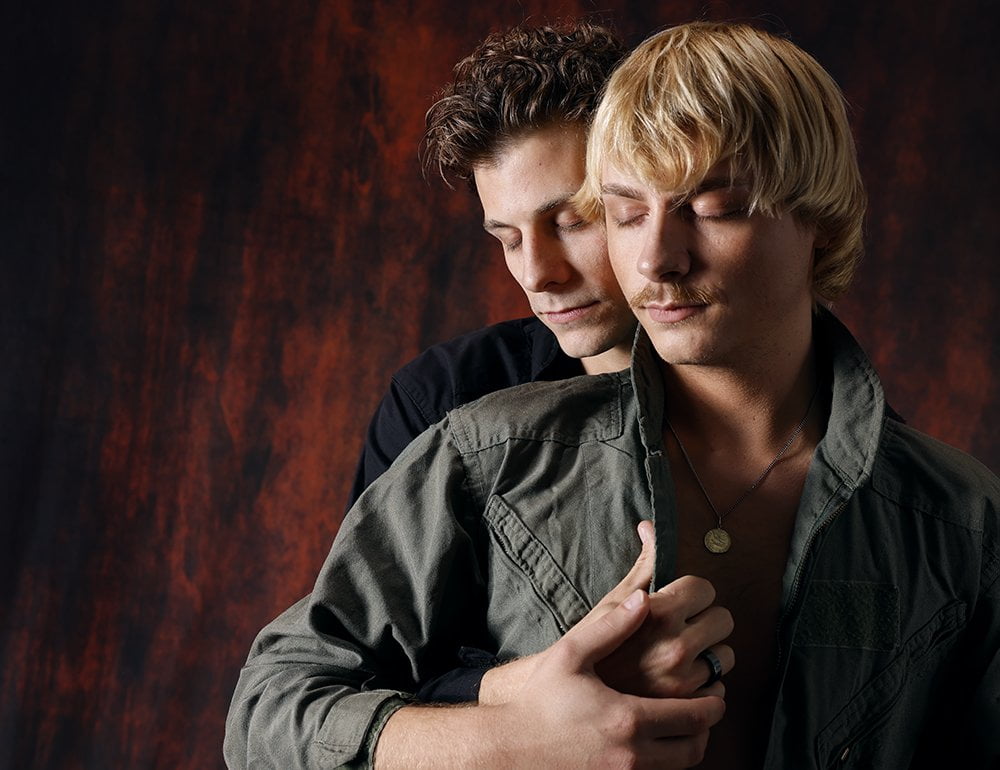 two men in embrace, eyes closed