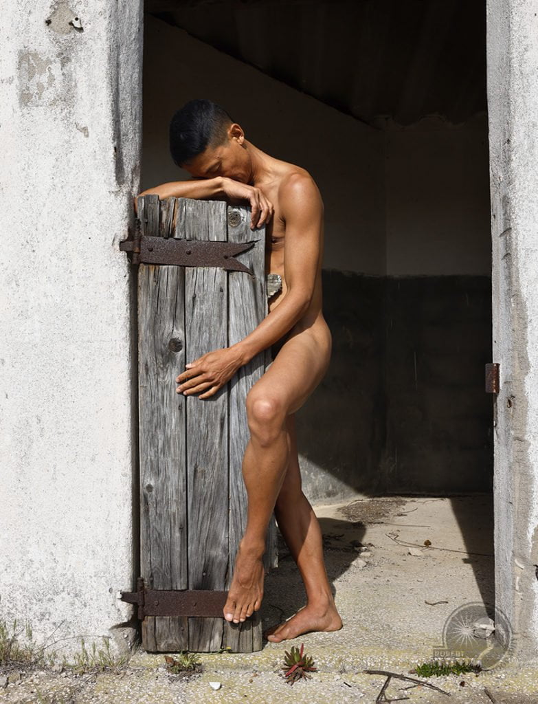 nude man in old barn