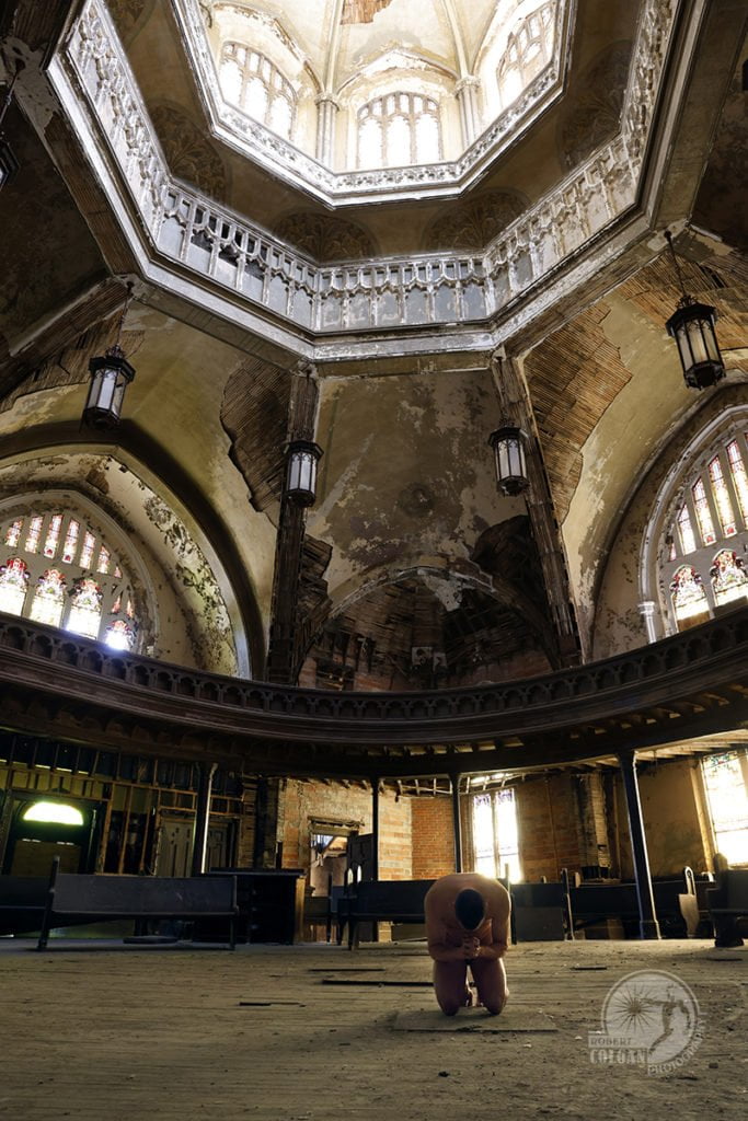 nude man prays in abandoned church