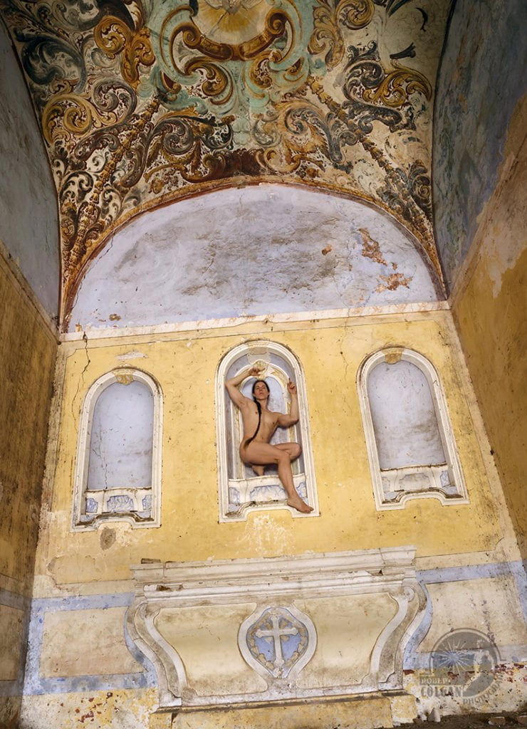 nude man in archway over altar in old abandoned monastery