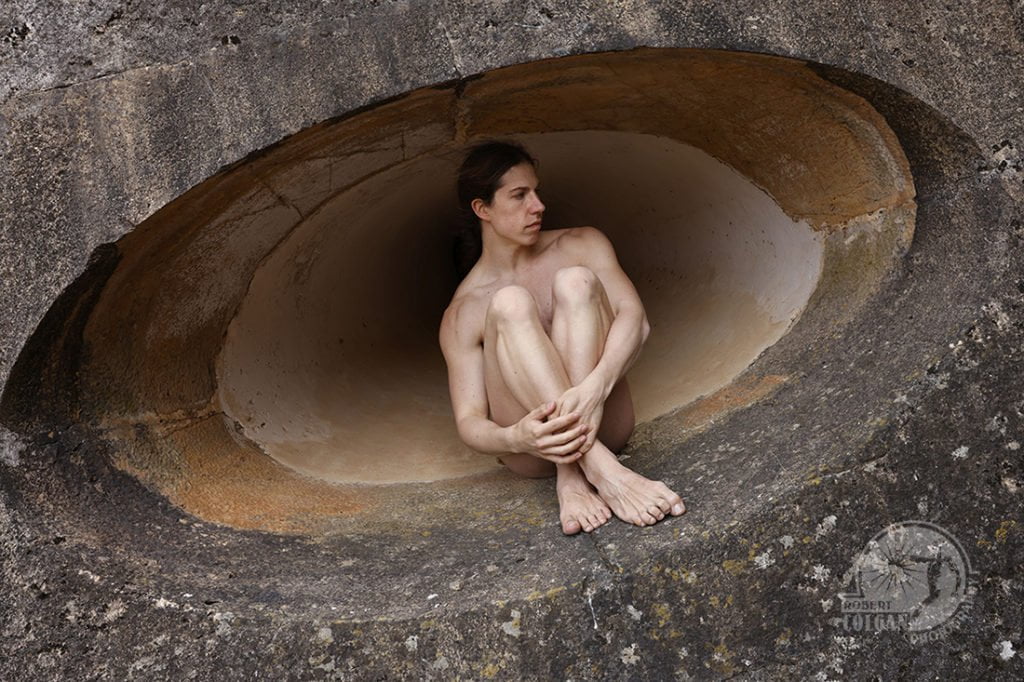 nude man sitting in oval shape