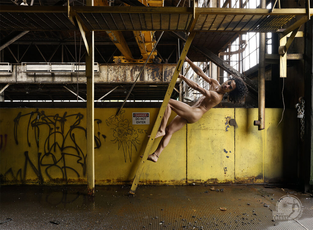 nude man climbs up ladder on backside