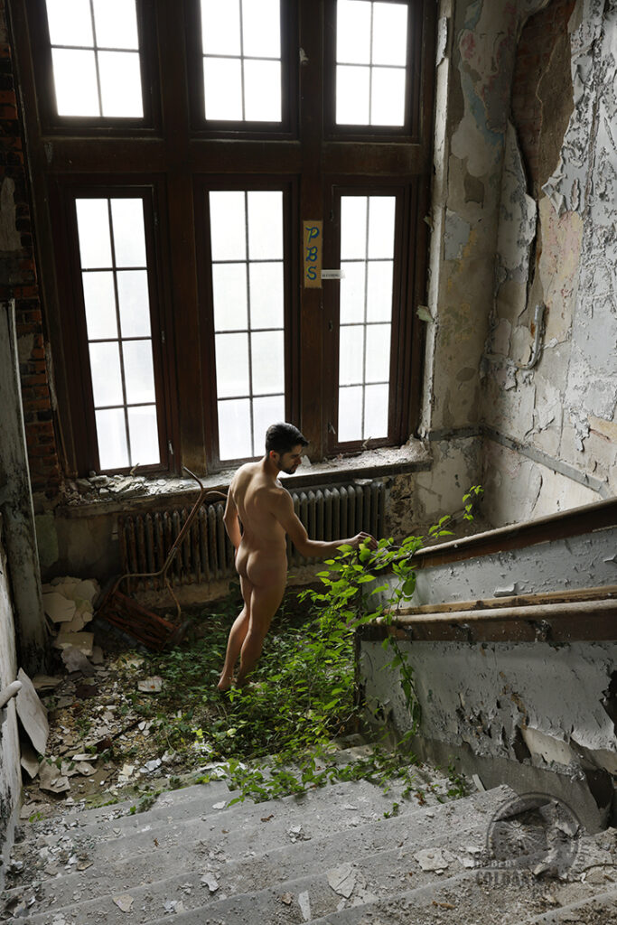 nude man on overgrown staircase