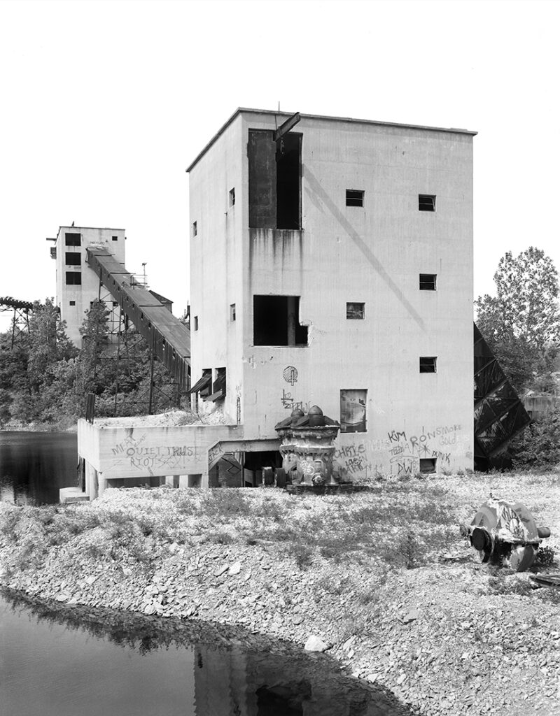 black and white of old quarry stone crusher buildings