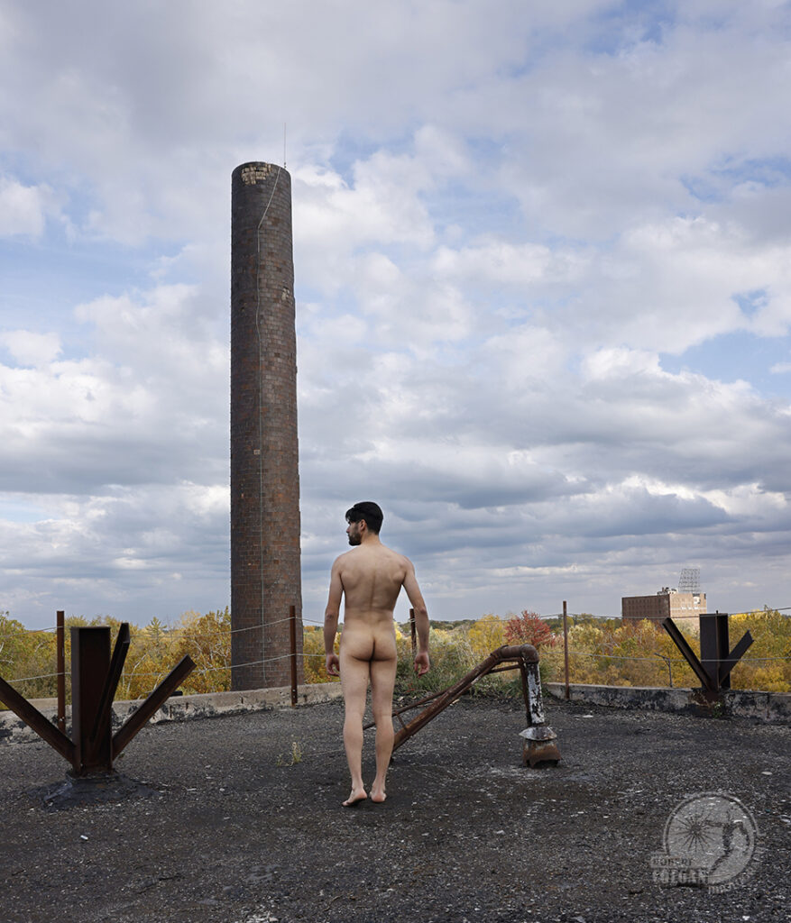 nude man on roof of abandoned factory