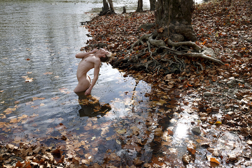 nude man in river arching back