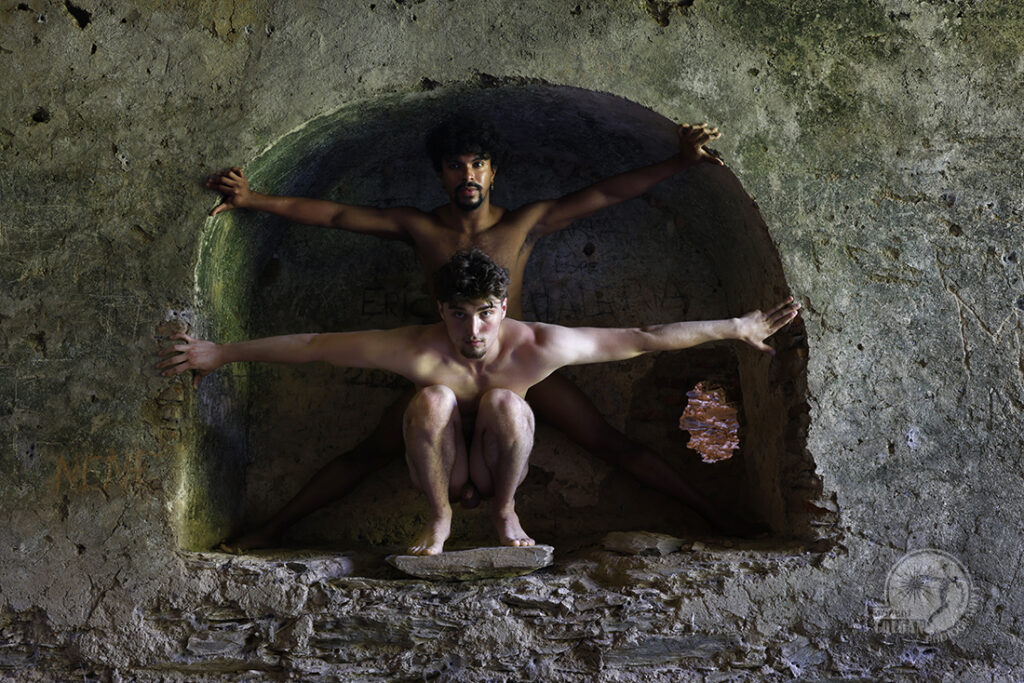 two nude men inside wall niche of ancient building