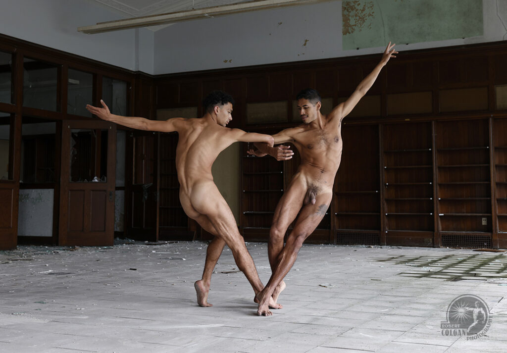two nude men dance in abandoned library