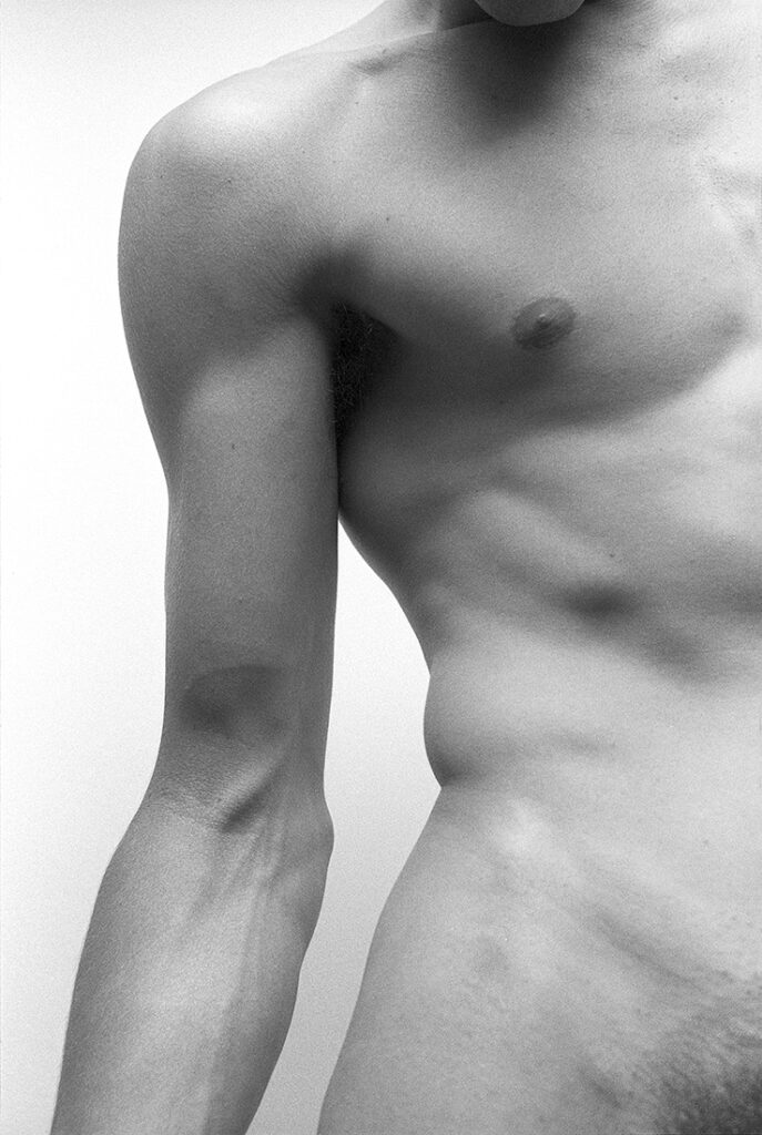 monochrome nude close-up of arm and partial chest
