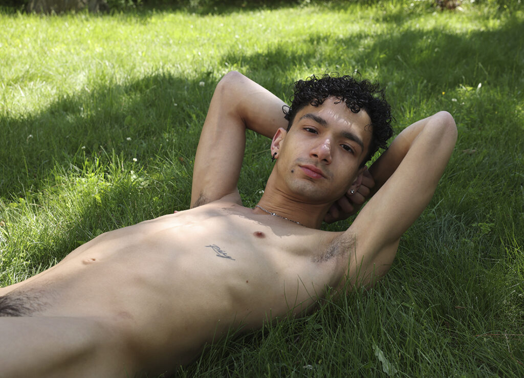 seminude man laying on grass