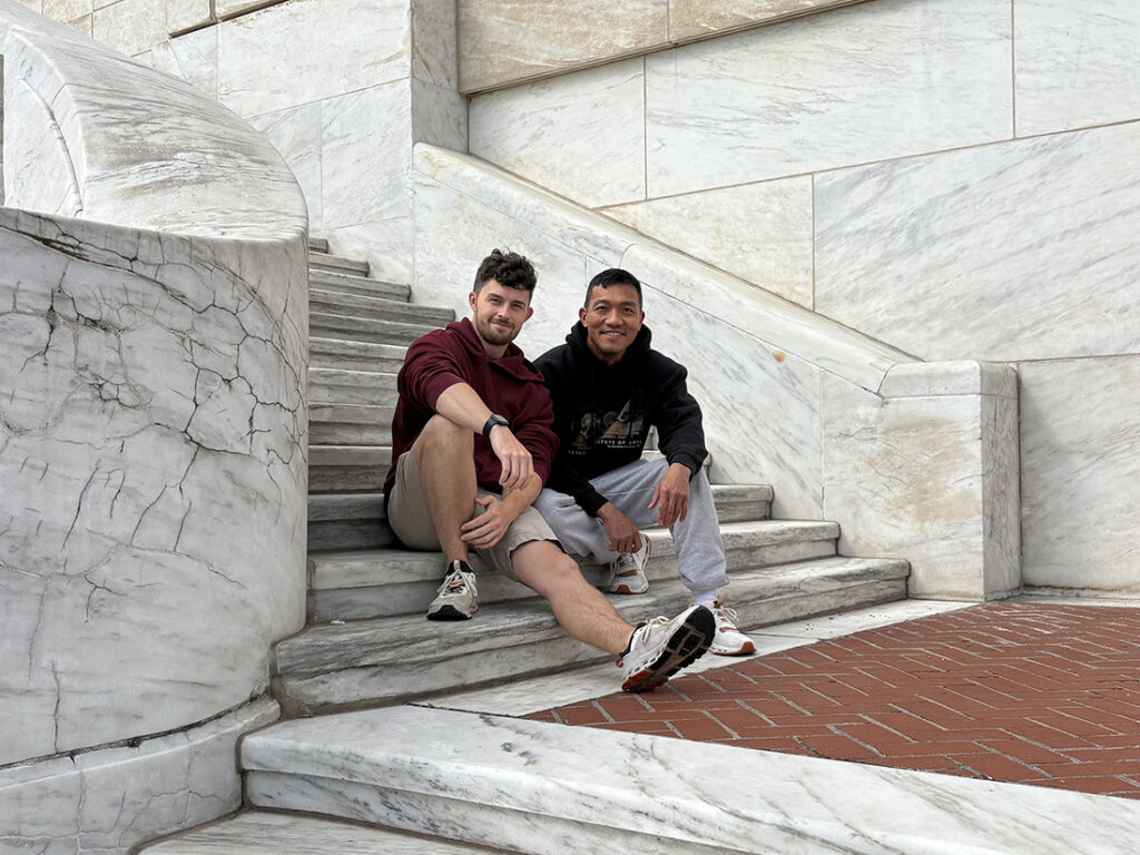 Two guys sitting on stairs